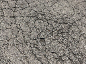 A close up of the cracked asphalt surface