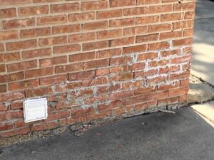 A brick wall with graffiti on it.